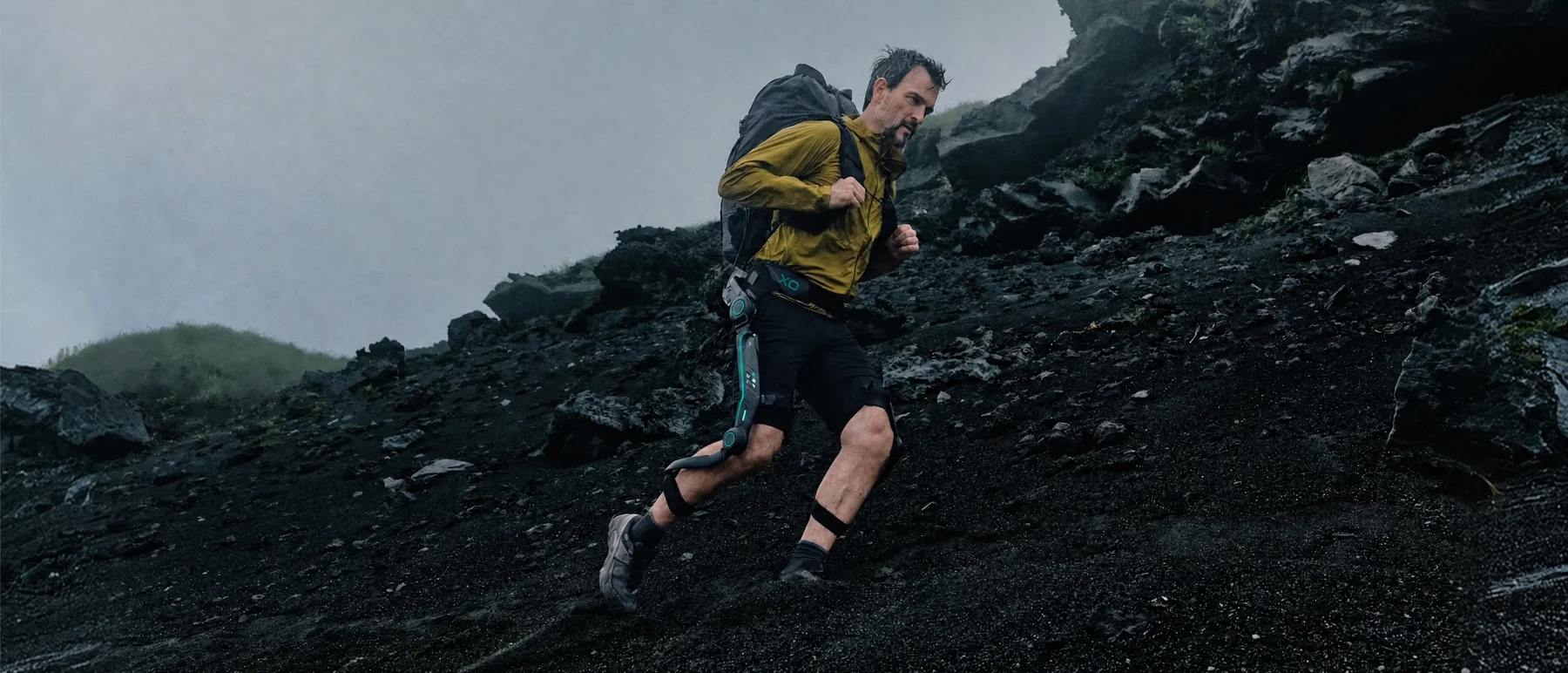 Adult outdoors on a rocky climb wearing the supplied concept